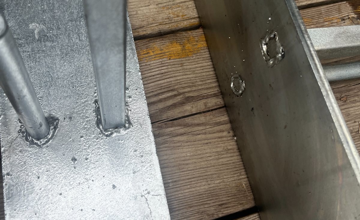 Close-up of the welds above and below each peg on an 8 mm thick galvanized footing