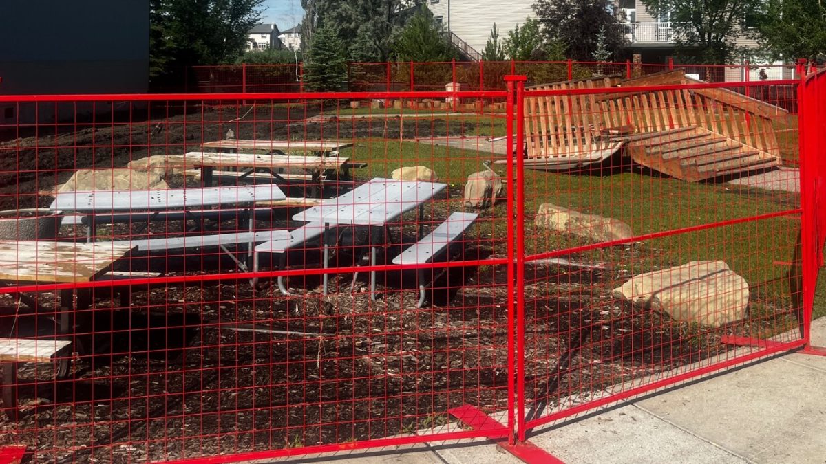 Red temporary fence closing off a landscaping work area