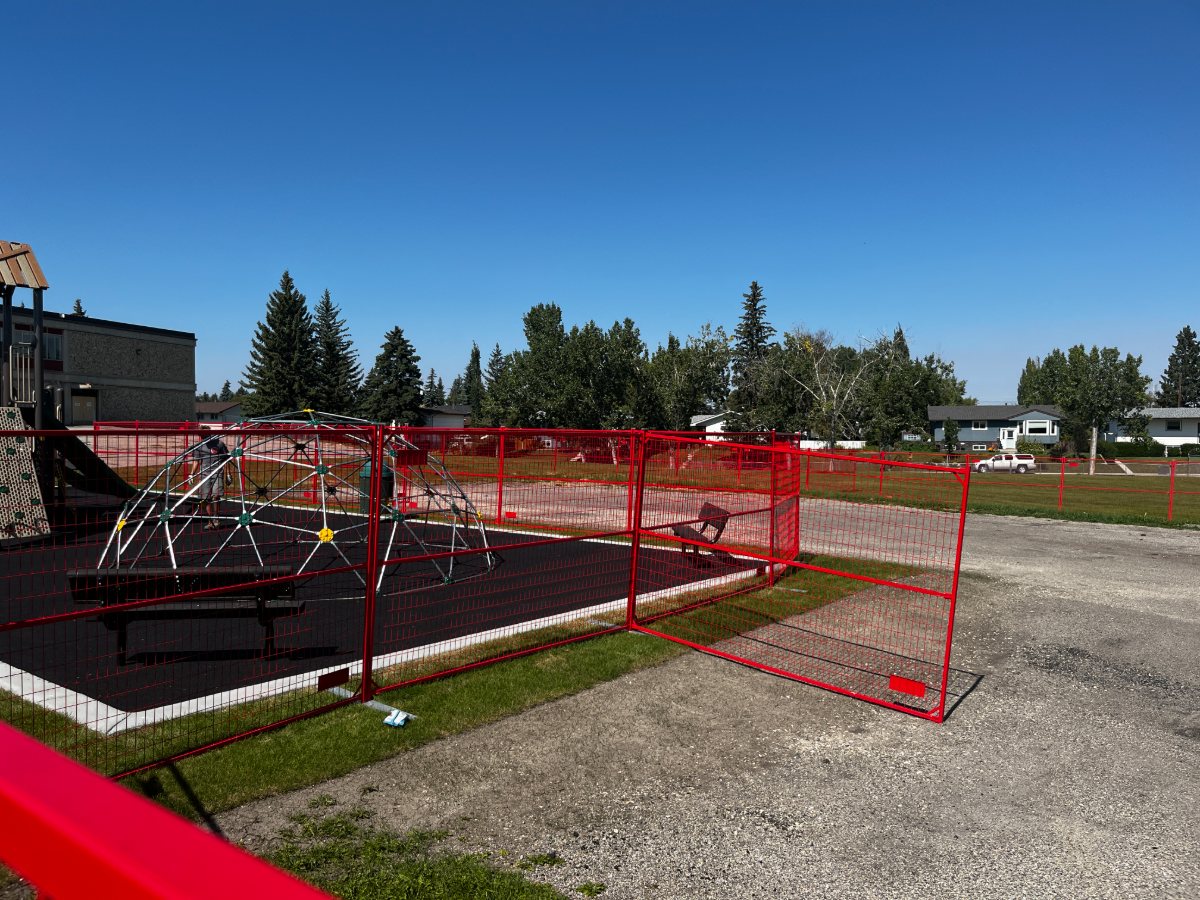 Yellow temporary fence enclosing a school playground